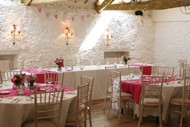 Sweet pink flowers and polk dot wedding reception decor | Confetti.co.uk