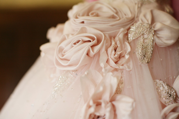 Blush pink wedding dress with rose detail | Confetti.co.uk