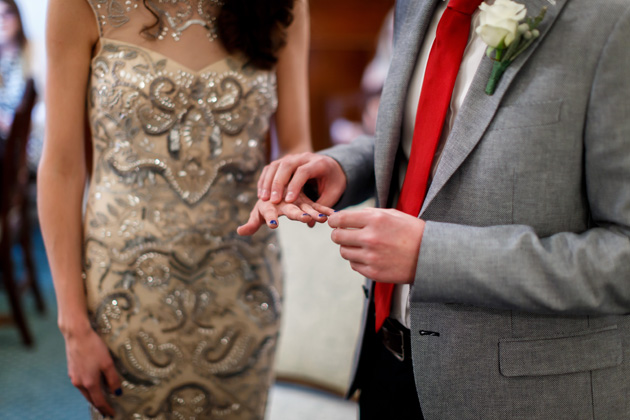 The groom placing the ring on the brides finger | Confetti.co.uk