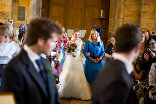 Bride walking down the aisle with her mum | Confetti.co.uk