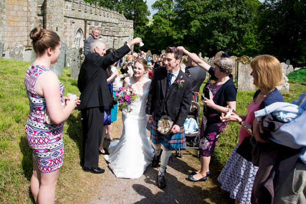 Wedding guests throwing confetti over the newlyweds | Confetti.co.uk