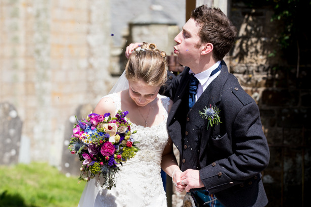 Groom blowing confetti of the brides hair | Confetti.co.uk