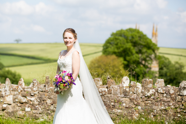 Bride in her Mon Cheri lace wedding dress | Confetti.co.uk