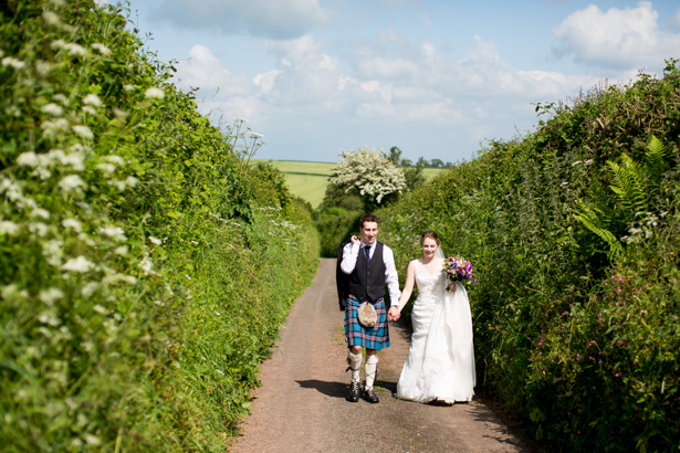 Bride and groom walking to the venue | Confetti.co.uk