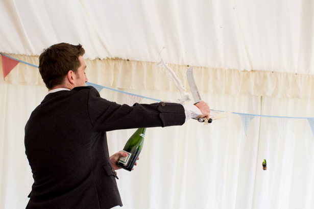 Groom using a sword to  to open the champagne! | Confetti.co.uk