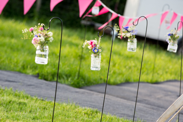 Jars with wildflowers leading the way to the venue | Confetti.co.uk