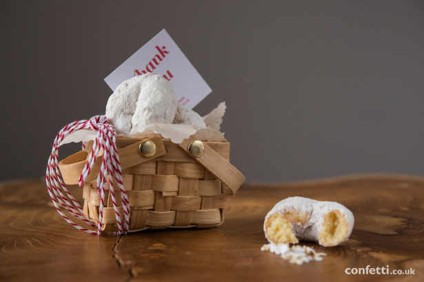 Tuck a few mini doughnuts into a small basket so your guests have a sweet treat to tuck into on the ride home from Confetti.co.uk