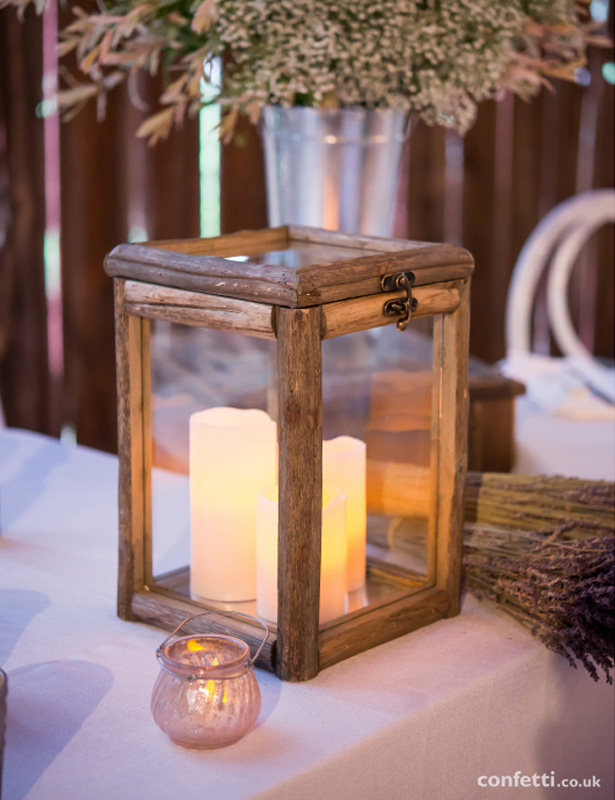 Wooden box centrepiece with white pillar candles| Rustic Wedding Centrepieces for a Barn Wedding | Confetti.co.uk   