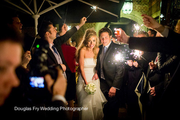 Styling Autumn Wedding | Real Wedding Autumn Wedding Entertainment Ideas | Wedding guests waving Sparklers as the bride and groom leave the venue |Image courtesy of Douglas Fry Wedding Photographer |Confetti.co.uk