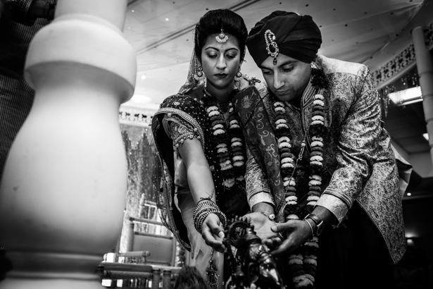 Bride and groom with the Lord Genesha during their ceremony | Traditional Hindu wedding customs | Confetti.co.uk