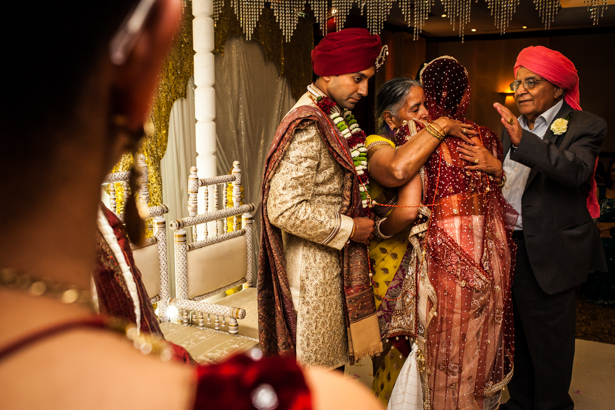 Bride embracing her family members after the Hindu ceremony | Traditional Hindu wedding customs | Confetti.co.uk