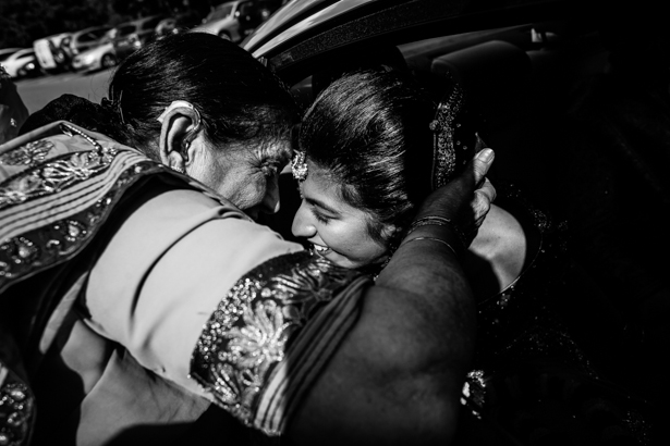 Emotional wedding guest embracing the bride before she leaves| Traditional Hindu wedding | Confetti.co.uk