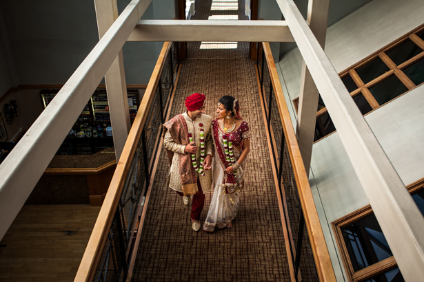 The bride and groom in traditional Indian wedding outfits captured by Kabilan Raviraj| Bride and groom walking side my side | Confetti.co.uk