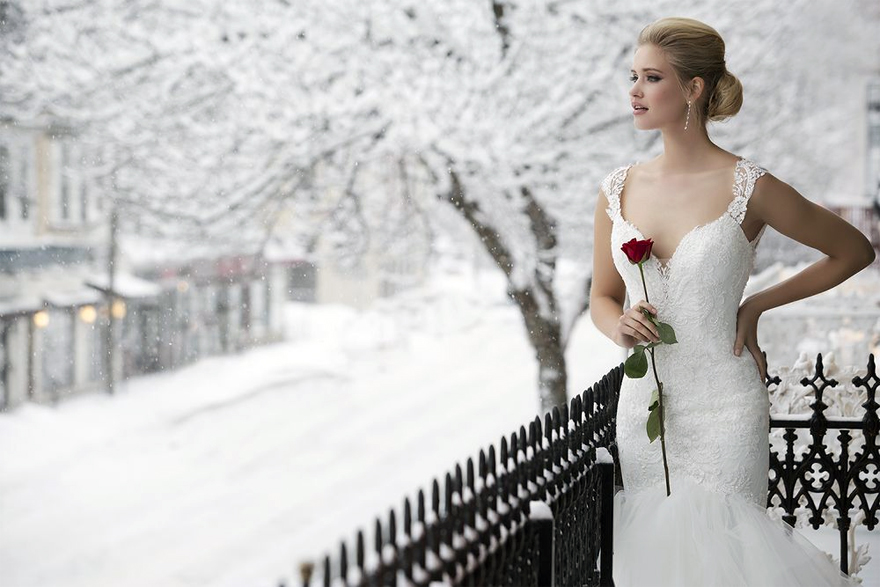 Winter Bride with Red Rose - Dress Style 8827 Lace Mermaid Gown with Tulle Handkerchief Skirt by Justin Alexander | Confetti.co.uk