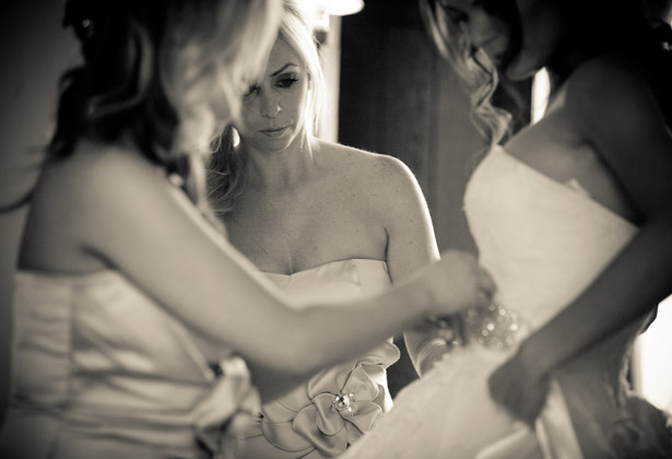 How to Choose Your Bridesmaids | Bridesmaids helping the bride with her detailed belt | Confetti.co.uk 