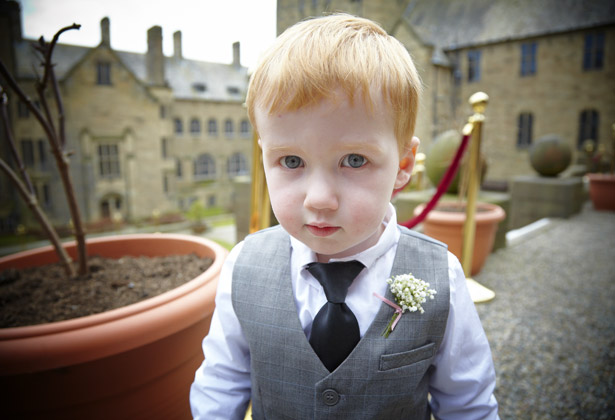 Dapper page boy with buttonhole at Bangor University wedding venue | Confetti.co.uk