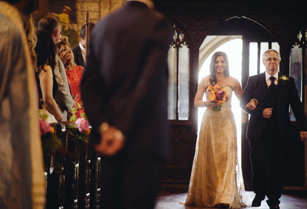 Bride in her gold dress walking down the aisle with her father | Francesca & Arun's Fusion Real Wedding | Confetti.co.uk  