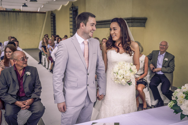 Bride in white strapless Pronovias dress with her groom, in a grey suit with coral tie | Morgan and James Real Wedding By Infinity Weddings | Confetti.co.uk