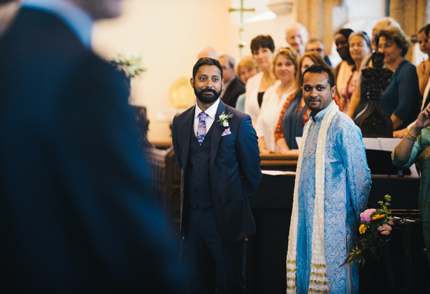 Groom in his blue Paul Smith suit along with his best man in a traditional blue sherwani, waiting for the bride at the altar | Francesca & Arun's Fusion Real Wedding | Confetti.co.uk  