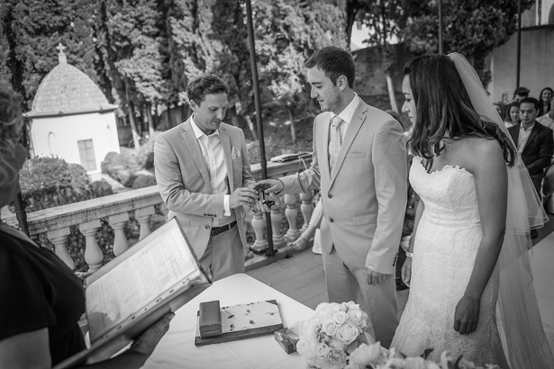 Groom taking the wedding rings from his best man | Morgan and James Real Wedding By Infinity Weddings | Confetti.co.uk