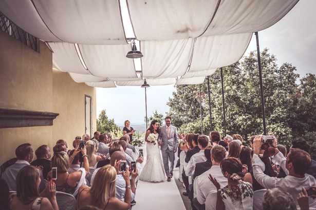 Guests talking pictures of the newlyweds | Morgan and James Real Wedding By Infinity Weddings | Confetti.co.uk