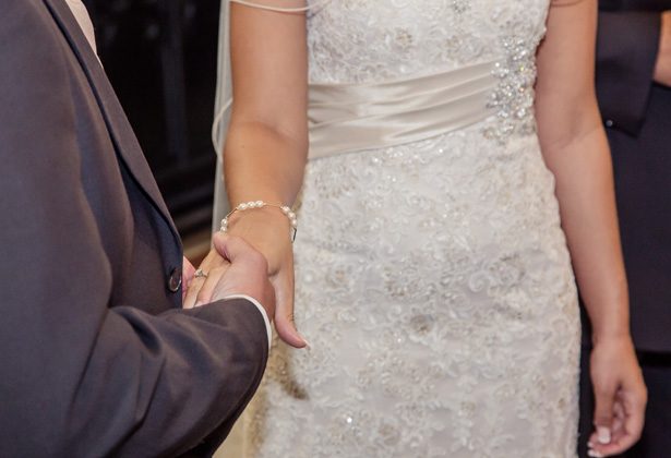 Groom placing the ring on the brides hand | Becki and Rob’s Real Wedding By Jenny Martin Photography | Confetti.co.uk