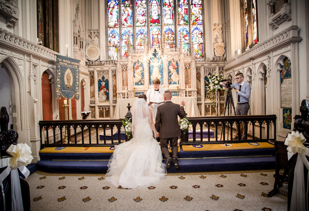 Bride and groom kneeling at the altar| Becki and Rob’s Real Wedding By Jenny Martin Photography | Confetti.co.uk