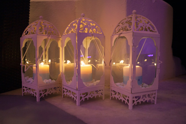 White Moroccan lamps with candles| Wedding reception at the Pantheon villas Santorini | Dasha and Steve's Real Wedding In Greece | Marryme in Greece | Confetti.co.uk