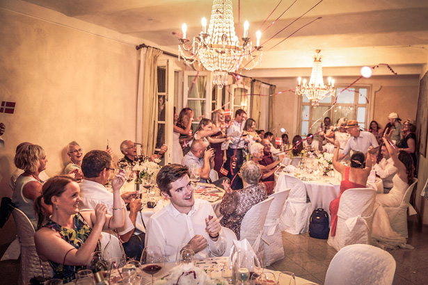 Guests celebrating the wedding with party poppers | Wedding reception at Villa Bucciano , Tuscany | Morgan and James Real Wedding By Infinity Weddings | Confetti.co.uk