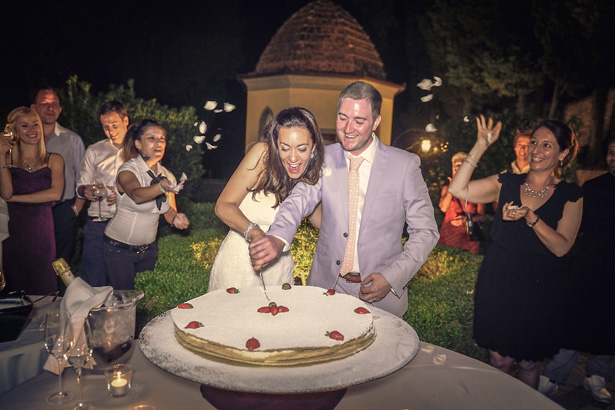 Bride and groom cutting their wedding cake | Wedding reception at Villa Bucciano , Tuscany | Morgan and James Real Wedding By Infinity Weddings | Confetti.co.uk