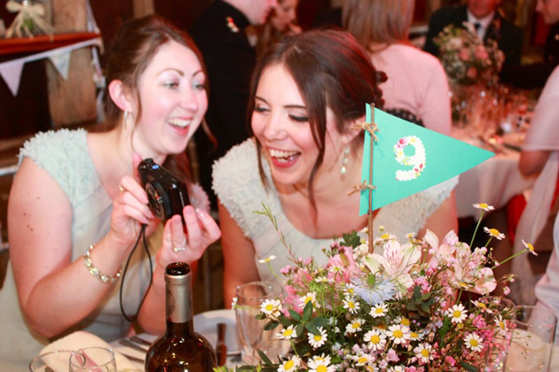 Wedding Worth Selfie | Bridesmaids laughing at pictures on their digital camera | Confetti.co.uk