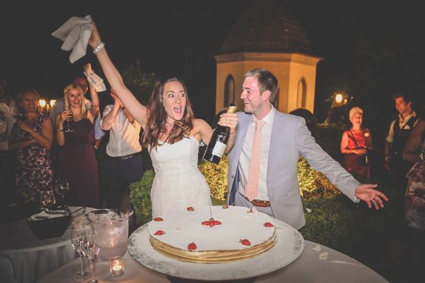 Bride and groom celebrating with champagne| Wedding reception at Villa Bucciano , Tuscany | Morgan and James Real Wedding By Infinity Weddings | Confetti.co.uk