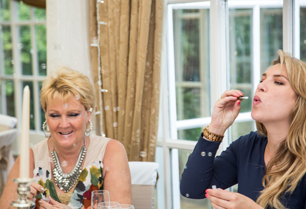 Wedding guests blowing bubbles at the wedding reception| Becki and Rob’s Real Wedding By Jenny Martin Photography | Confetti.co.uk