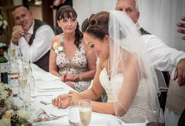 Bride at the top table enjoying the grooms speech | Becki and Rob’s Real Wedding By Jenny Martin Photography | Confetti.co.uk