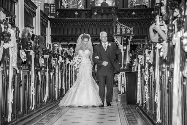 Bride walking down the aisle with her father | Becki and Rob’s Real Wedding By Jenny Martin Photography | Confetti.co.uk