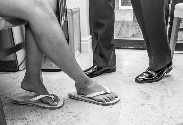 Bride wearing flip flops as she’s getting ready for her wedding day | Becki and Rob’s Real Wedding By Jenny Martin Photography | Confetti.co.uk