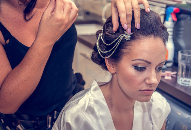 Makeup artist putting the final touches to the brides look | Silver vintage head piece | Becki and Rob’s Real Wedding By Jenny Martin Photography | Confetti.co.uk