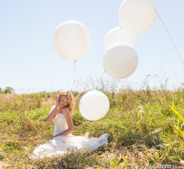 Bride in a summer meadow | Confetti.co.uk