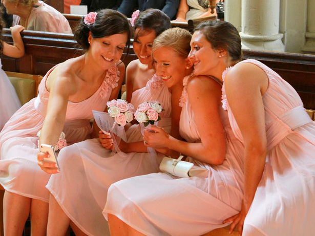 Wedding Worthy Selfie | Bridesmaids taking a selfie at the ceremony | Confetti.co.uk 