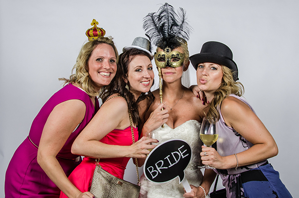 Wedding Worth Selfie | Bride and her bridesmaids having fun with vintage props | Confetti.co.uk