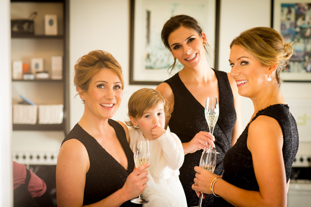 Bridesmaids in black sleeveless dress with the flower girl  | Abigail and Chris's Real Christmas Wedding | Confetti.co.uk 