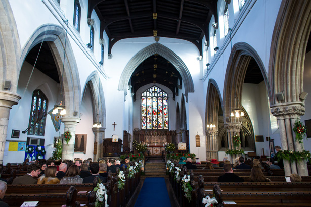 Wedding ceremony at All Saints Church in Stamford | Abigail and Chris's Real Christmas Wedding | Confetti.co.uk 