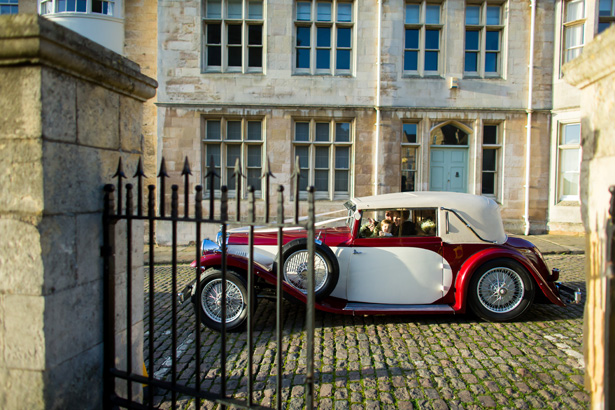 Red and white vintage wedding car| Abigail and Chris's Real Christmas Wedding | Confetti.co.uk 