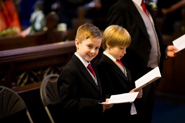 Ushers singing along to the hymns | Abigail and Chris's Real Christmas Wedding | Confetti.co.uk 