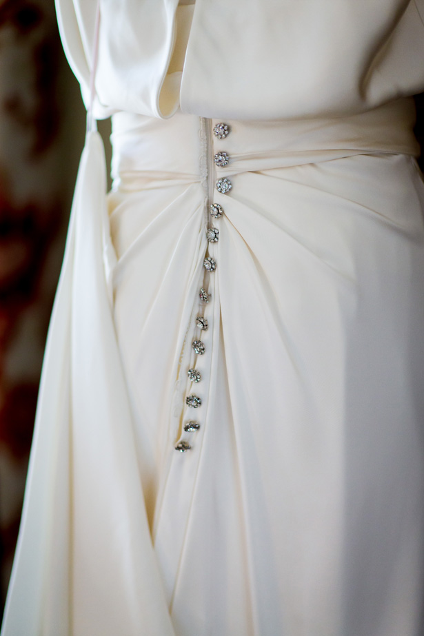 1920’s inspired white wedding dress | Diamante detail buttons on the back of the wedding dress | Abigail and Chris's Real Christmas Wedding | Confetti.co.uk 