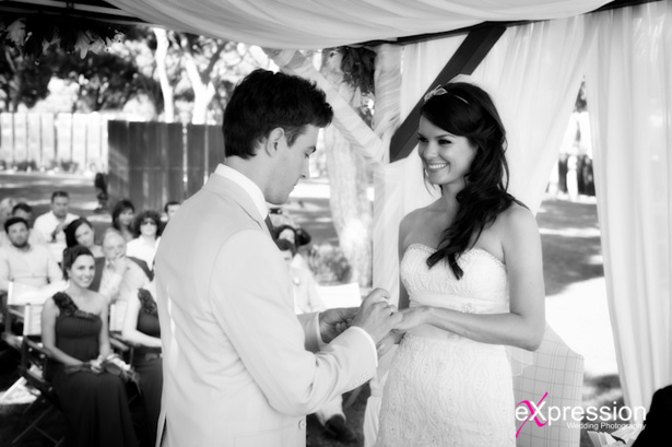 Groom placing the wedding ring on the bride |Wedding ceremony at the Sheraton Algarve Hotel, in the Algarve, Portugal.| Debora and James’s real destination wedding | Confetti.co.uk