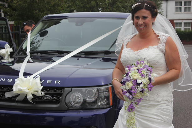 Bride arriving at the ceremony in a wedding Range Rover | Purple themed wedding| Rhiannon & Michael's Real Wedding | Confetti.co.uk