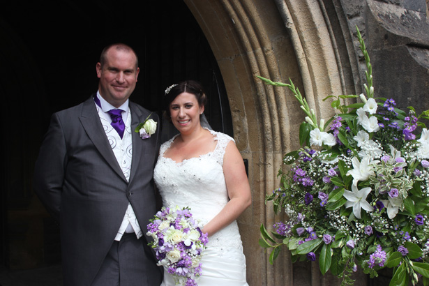 The newlyweds outside the church after the ceremony | Purple themed wedding| Rhiannon & Michael's Real Wedding | Confetti.co.uk