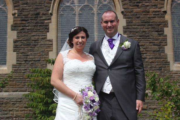 The newlyweds outside the church after the ceremony | Purple themed wedding| Rhiannon & Michael's Real Wedding | Confetti.co.uk