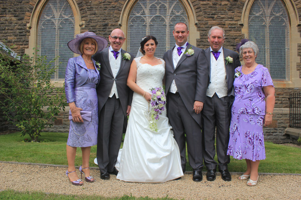 Bride and groom with their parents outside the church after the ceremony | Purple themed wedding| Rhiannon & Michael's Real Wedding | Confetti.co.uk